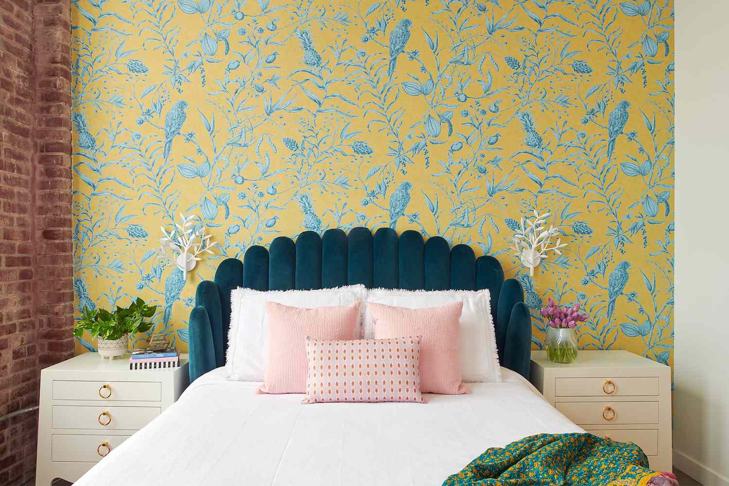 Floral wallpaper professionally installed behind a bedroom headboard