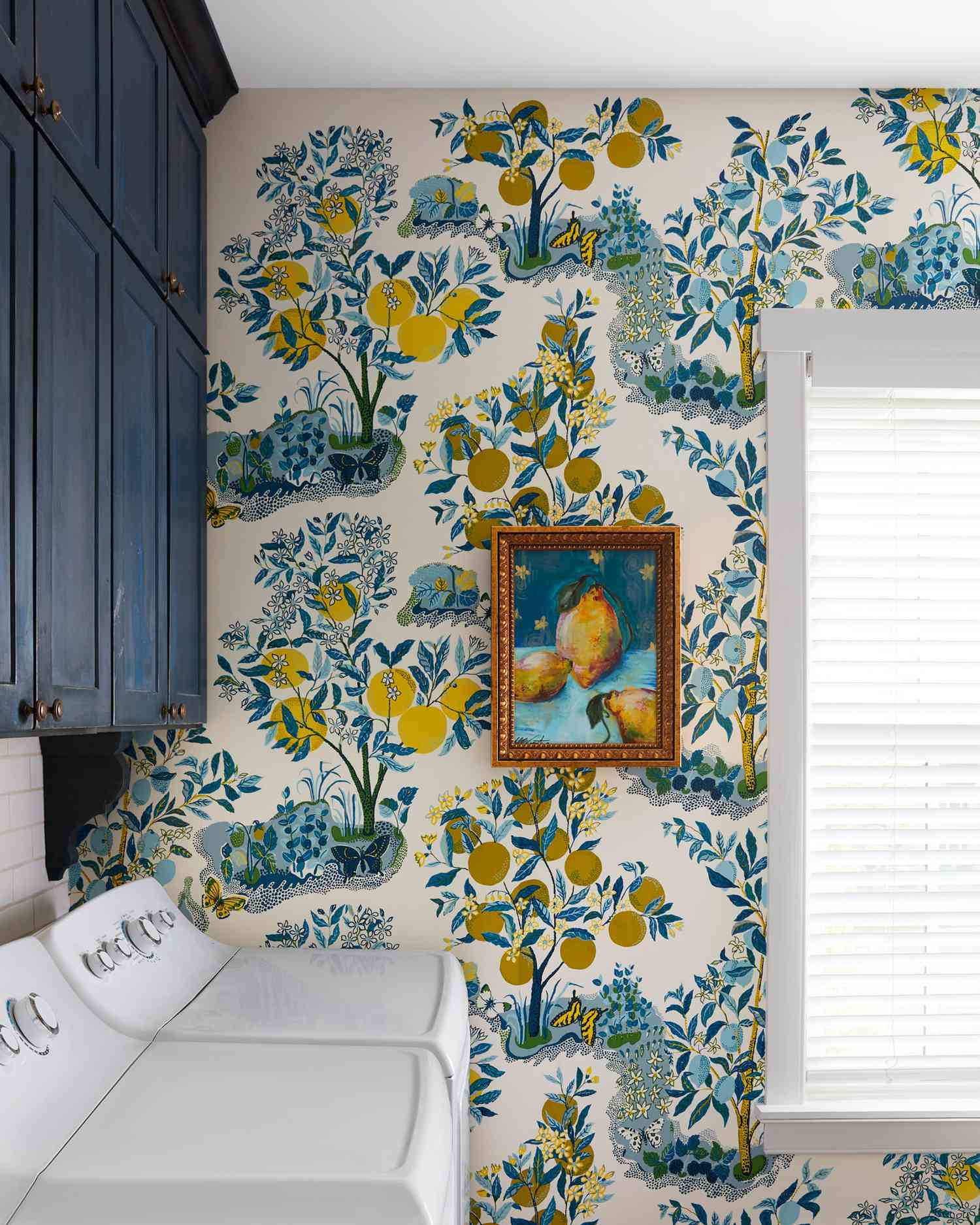 Botanical wallpaper surrounding a bright seating area